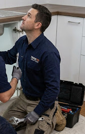Tradetek plumber inspecting pipes